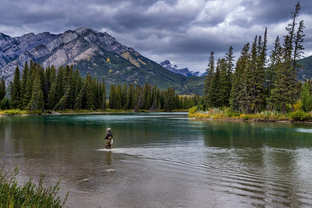 Fishing in the middle of a river.